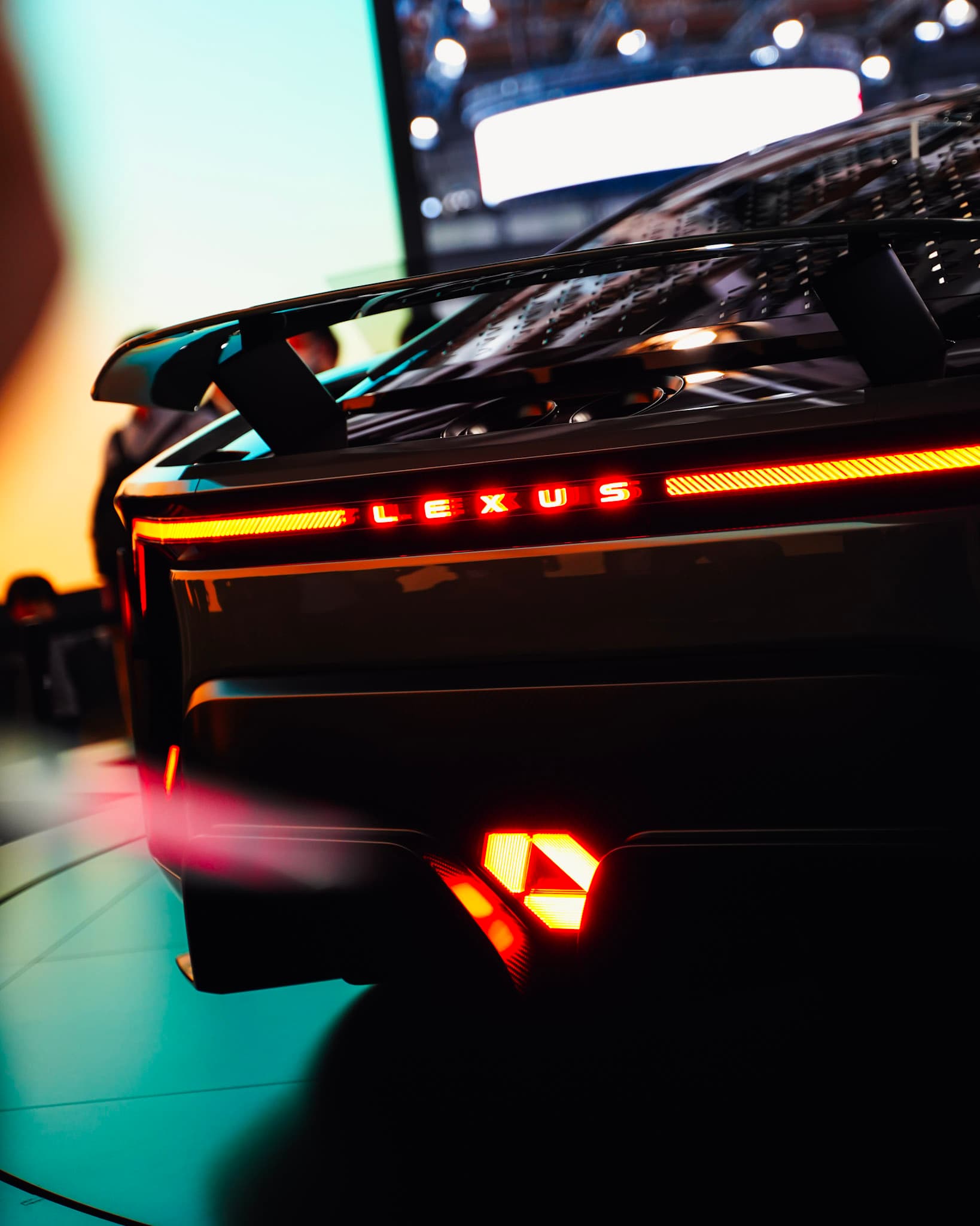Lexus LFA concept car rear, glowing taillights under dramatic show lighting